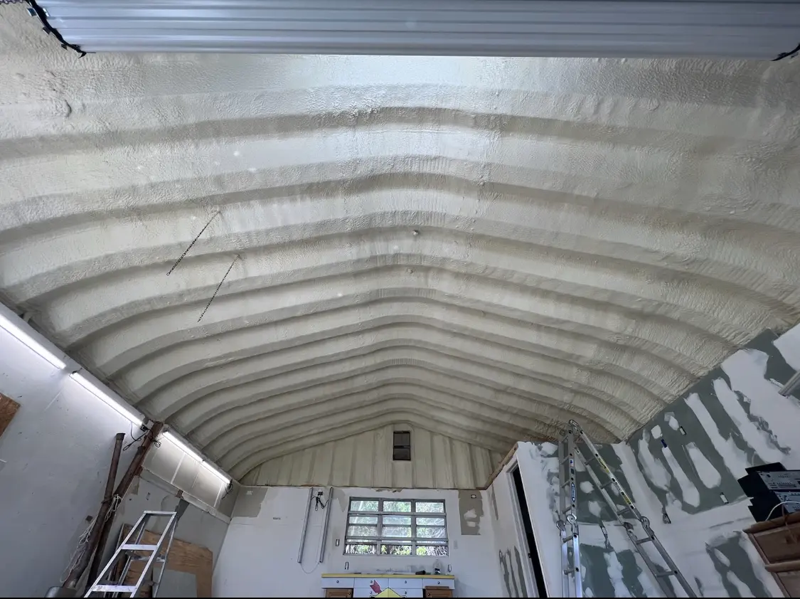Spray polyurethane foam applied to the underside of a metal roof deck in Tyler